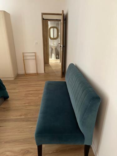 a blue bench in a room with a mirror at CARPENTRAS appartement situé dans le centre historique in Carpentras