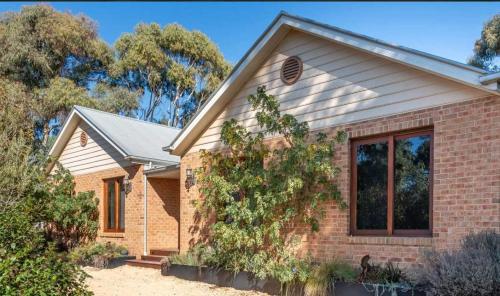 a brick house with a window at Relaxing Family Retreat with Outdoor Entertaining in Golden Square