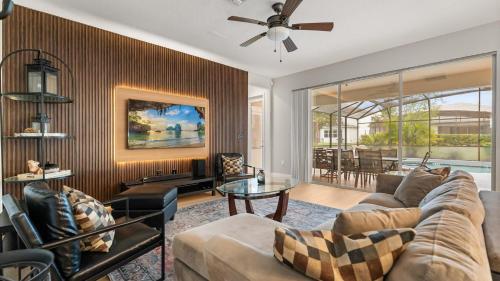 a living room with a couch and a table at 6BR Luxury Home with Private Pool and BBQ in Kissimmee