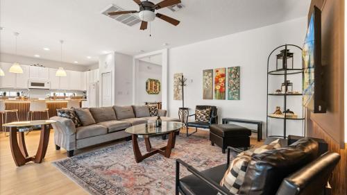 a living room with a couch and a table at 6BR Luxury Home with Private Pool and BBQ in Kissimmee