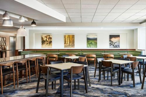 a dining room with tables and chairs at Fairfield Inn & Suites by Marriott Sheridan in Sheridan