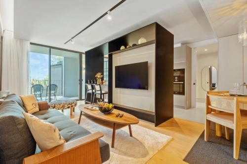 a living room with a couch and a table at Luxury 5-Star Stay at Savoy Insular in Funchal