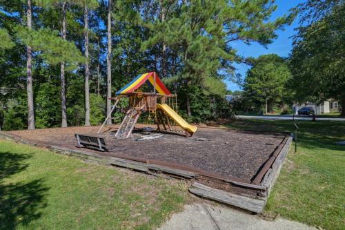 a playground with a slide in a yard at The Carolina Comfort House in Rose Creek