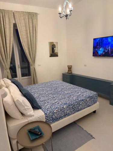 a bedroom with a bed and a table and a window at Casa Amelia in Capri