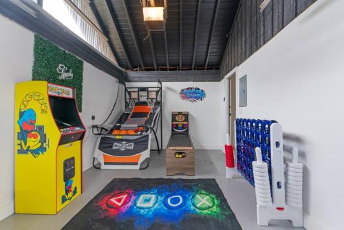 a room with a video game system and an arcade at Game Room - Modern Beautiful Home in Austin