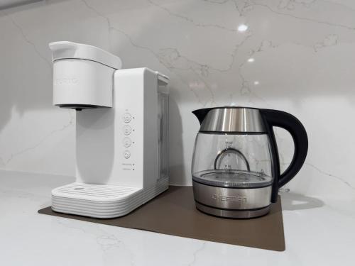 a coffee maker and a blender on a counter at Game Room - Modern Beautiful Home in Austin
