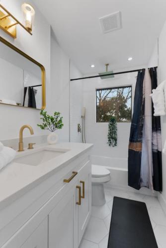 a white bathroom with a sink and a toilet at Game Room - Modern Beautiful Home in Austin