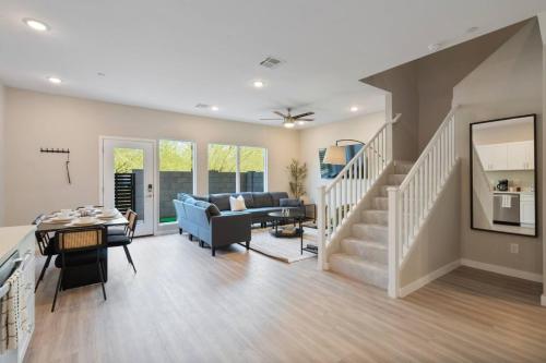 a living room with a staircase and a couch at Desert Oasis - Lux Suite w Pool by Stadium - Golf in Surprise