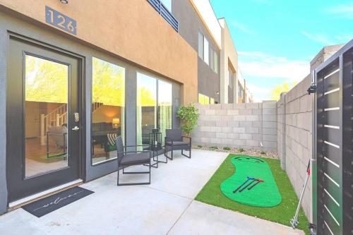 a patio with a table and chairs next to a building at Cozy Cactus - 5 Bed Suite w Pool - Stadium - Golf in Surprise