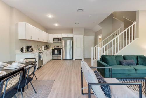 a living room with a couch and a table at Cozy Cactus - 5 Bed Suite w Pool - Stadium - Golf in Surprise