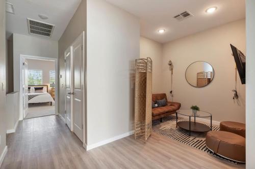 a living room with a couch and a mirror at Cozy Cactus - 5 Bed Suite w Pool - Stadium - Golf in Surprise