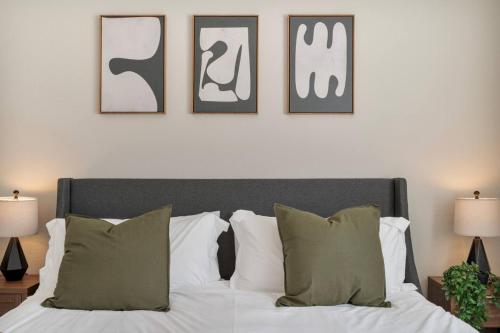 a bedroom with a bed with four pictures on the wall at Cozy Cactus - 5 Bed Suite w Pool - Stadium - Golf in Surprise
