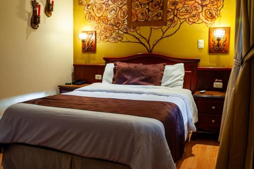 a bedroom with a large bed in a room at Hotel Campanario in Cuenca