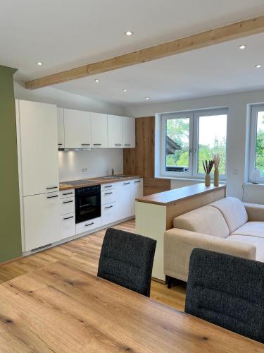 a kitchen and living room with a couch and a table at Landgasthof Gänsberg in Wiesloch