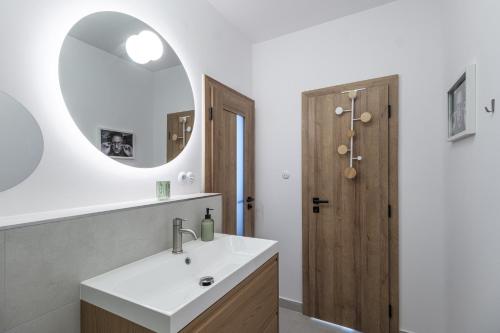 a bathroom with a sink and a mirror at The Nest - Komárno in Komárno