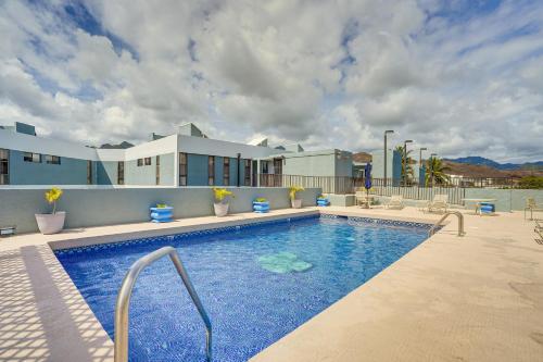 a large swimming pool with blue water in a building at 1 Mi to Beach, Remote Work Hub Modern Kailua Gem! in Kailua
