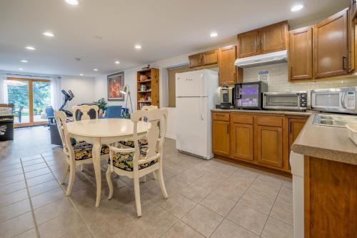 a kitchen with a table and a white refrigerator at Harmony Inn, Huntley Illinois in Huntley