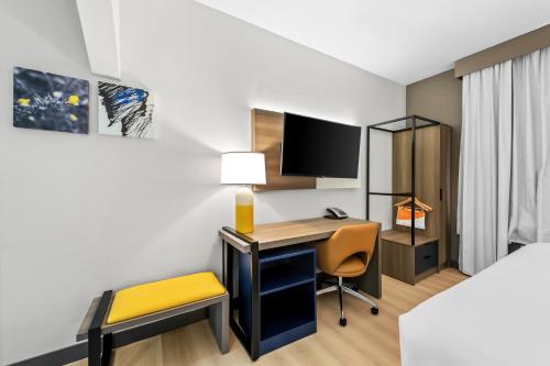 a hotel room with a desk and a chair at Comfort Suites Texarkana Texas in Texarkana - Texas