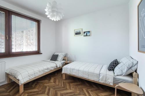 a bedroom with two beds and a window at The Nest - Komárno in Komárno