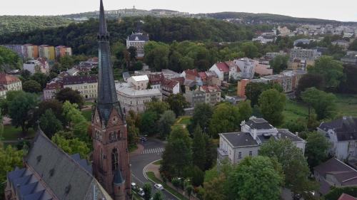 an aerial view of a city with a church at MVA House Teplice, Šanovský park in Teplice