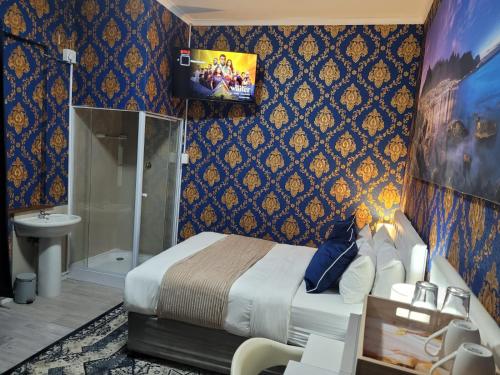 a bedroom with a king sized bed and a bathroom at Prime Executive Accommodation in Cape Town
