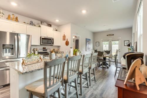 a kitchen and dining room with a counter and chairs at 7 Mi to Dtwn Augusta! Modern Family Home in Beech Island
