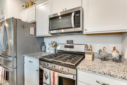 a kitchen with a stove and a microwave at 7 Mi to Dtwn Augusta! Modern Family Home in Beech Island