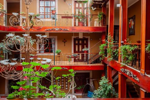 a building with a lot of plants on the balconies at Hotel Campanario in Cuenca