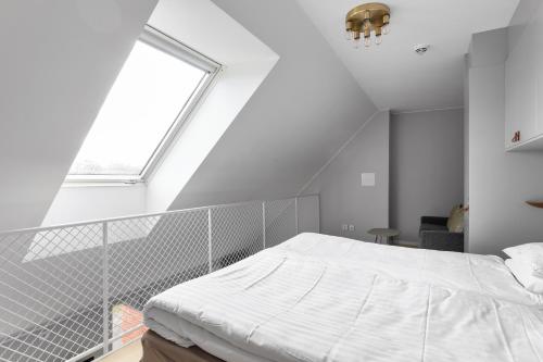 a white bed in a room with a window at Avanti Apartment Hotel in Stockholm