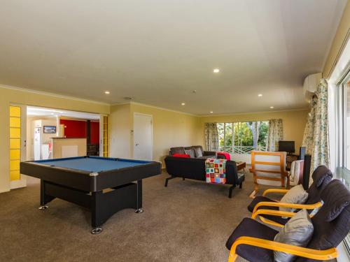 a living room with a pool table in it at Raetihi Garden Spa Villa in Raetihi