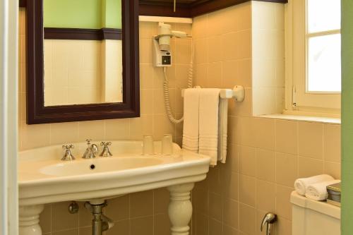 a bathroom with a sink and a mirror at Pousada Convento de Evora in Évora