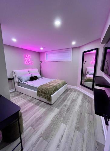 a bedroom with a bed and a pink wall at Modern Suite in Etobicoke - Near Airport & Downtown! in Toronto