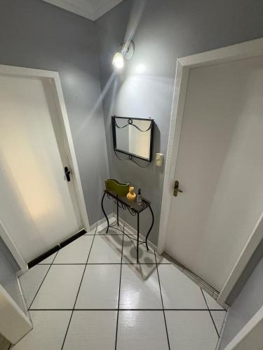 a room with a table and a mirror on the wall at Casa - Joinville in Joinville