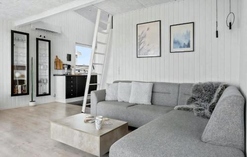 a living room with a couch and a coffee table at Deligt Feriehus Med Havudsigt in Karrebæksminde