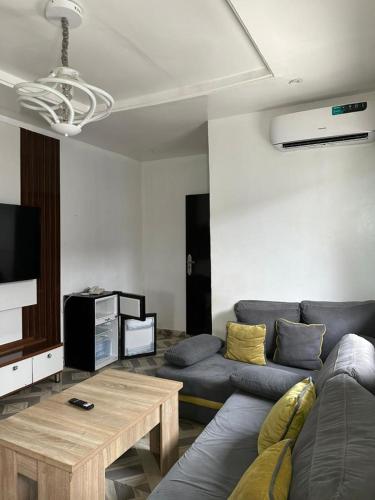 a living room with a couch and a table at Dee Rocket Hotel & Lounge in Ibadan