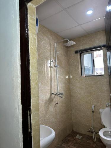 a bathroom with a shower and a toilet and a sink at Dee Rocket Hotel & Lounge in Ibadan