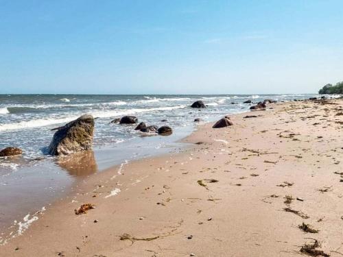 a beach with a bunch of rocks in the water at Tranquil Beach Retreat - By Traum in Idestrup