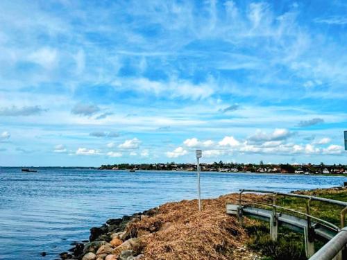 a view of a body of water with a bench at 4 person holiday home in Jægerspris-By Traum in Jægerspris
