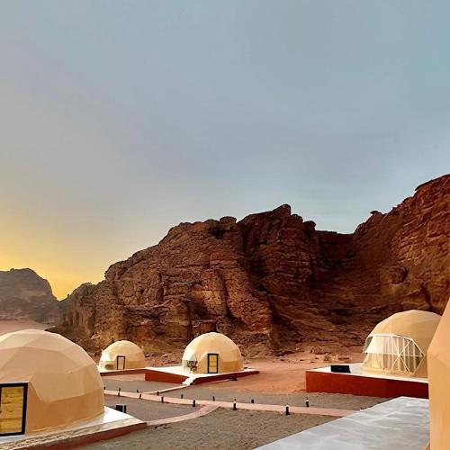 a group of domes in front of a mountain at Redsand Valley Retreat in Disah