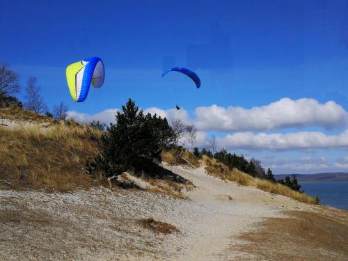 two kites flying in the sky over a beach at 6 person holiday home in Børkop-By Traum in Børkop