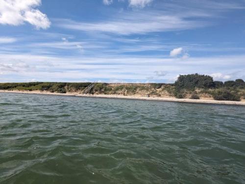 a view of a beach from a boat in the water at 4 person holiday home in Haderslev in Haderslev
