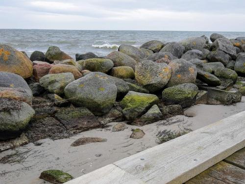 a pile of rocks on the beach near the ocean at 5 person holiday home in Karrebæksminde in Karrebæksminde