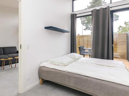 a bedroom with a bed and a large window at Holiday home in a park in Gilleleje in Gilleleje