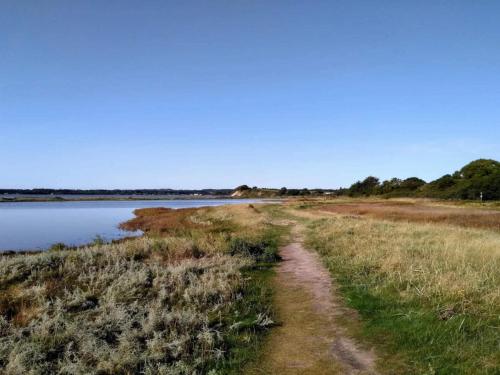a dirt road next to a body of water at 8 person holiday home in Rønde-By Traum in Rønde