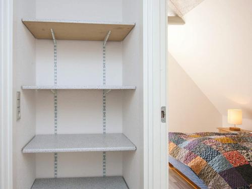 a room with shelves next to a bed at 4 person holiday home in Ansager in Ansager