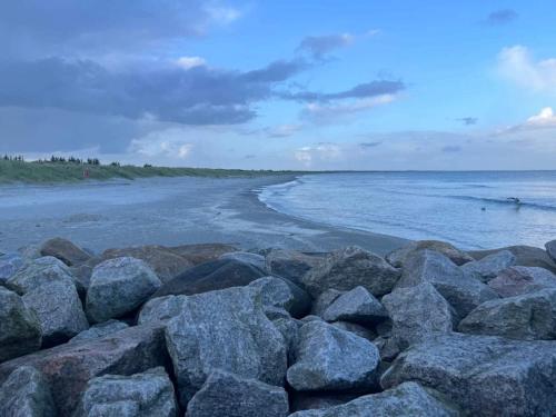 a pile of rocks on a beach near the water at 6 person holiday home in Ålbæk-By Traum in Ålbæk