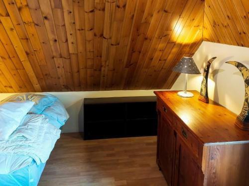 a bedroom with a bed and a lamp on a dresser at 6 person holiday home in Thisted in Thisted