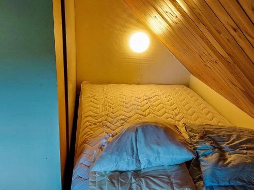 a small bed in a small room with a ceiling at 6 person holiday home in Thisted in Thisted