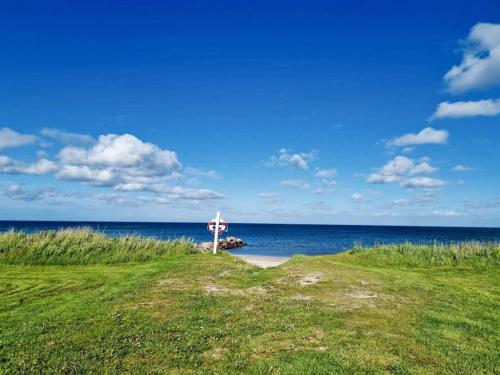a cross on the side of a road near the ocean at 4 star holiday home in Sæby-By Traum in Sæby