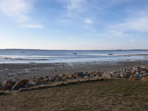a group of rocks on a beach near the water at 5 person holiday home in Nibe-By Traum in Nibe